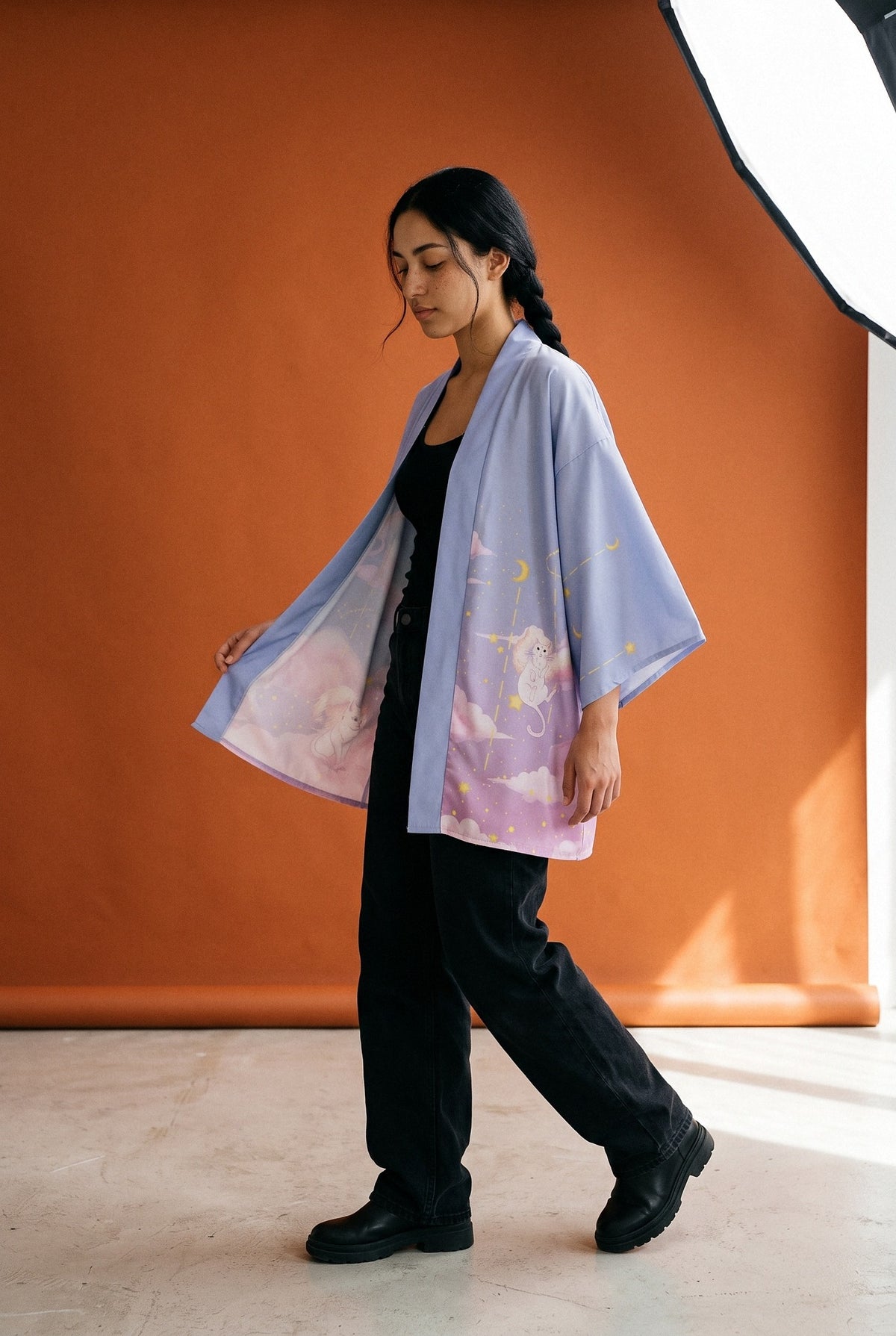 Kimono japonés Hirune, gato soñador, azul lavanda: modelo caminando, en estudio, fondo naranja óxido